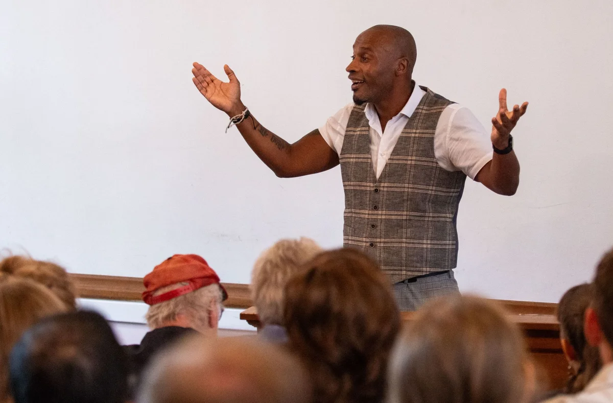 Augusto speaking at an event